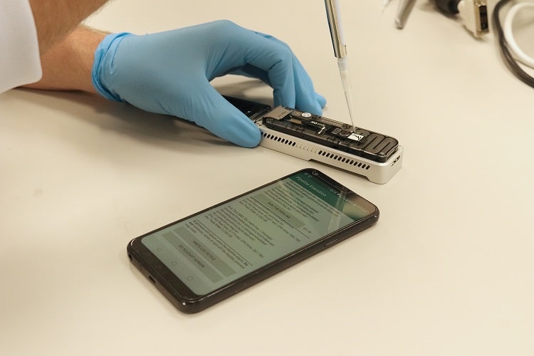 Electronic test being held next to a phone